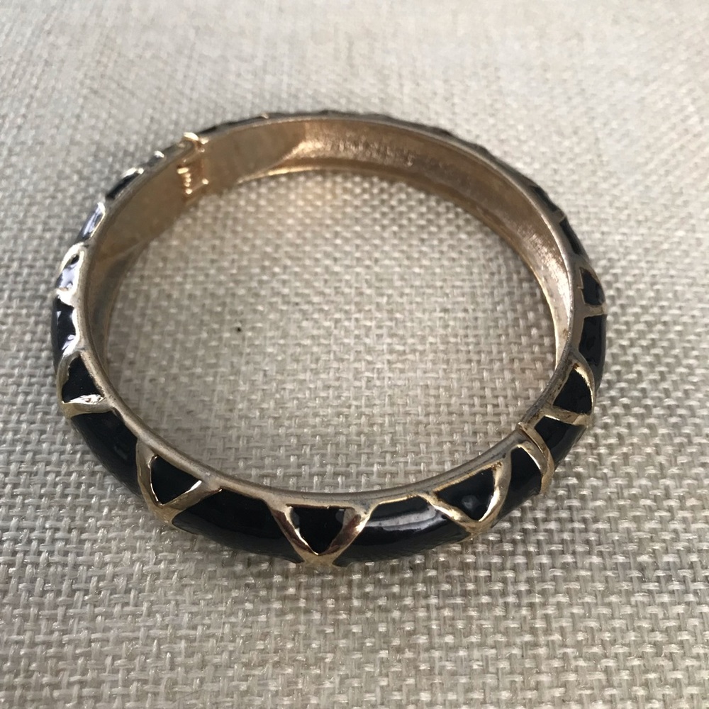 Black and gold tone magnetic opening bracelet.